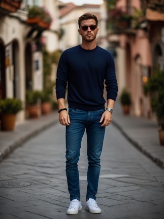 Navy Crew-neck Sweater · Blue Jeans · White Low Top Sneakers · Dark Brown Sunglasses · Silver Watch · Black Beaded Bracelet