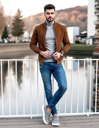 Tobacco Suede Bomber Jacket · Grey Turtleneck · Blue Skinny Jeans · Grey Suede Low Top Sneakers · Black Leather Watch · Dark Brown Bracelet