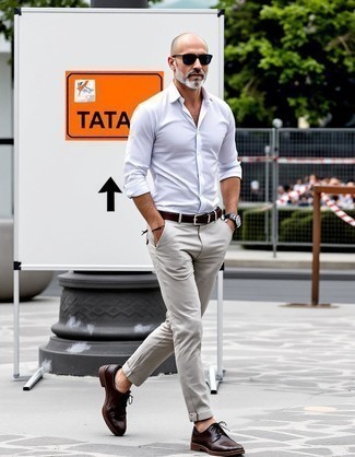 White Long Sleeve Shirt · Beige Chinos · Dark Brown Leather Derby Shoes · Dark Brown Leather Belt · Black Sunglasses · Silver Watch
