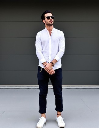 White Long Sleeve Shirt · Navy Chinos · White Leather Low Top Sneakers · Black Sunglasses · Brown Beaded Bracelet · White No Show Socks