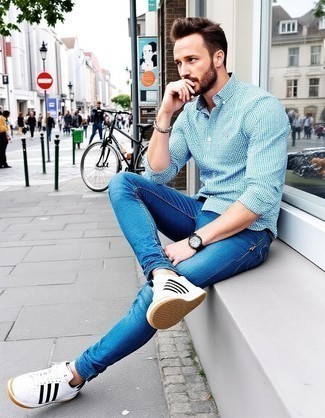 White and Navy Gingham Long Sleeve Shirt · Blue Jeans · White and Black Leather Low Top Sneakers · Black Leather Watch · Dark Brown Beaded Bracelet