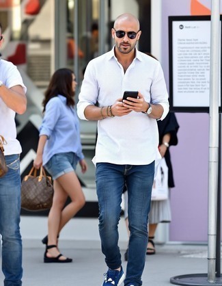 White Long Sleeve Shirt · Navy Jeans · Navy Athletic Shoes · Charcoal Sunglasses · Silver Watch · Silver Bracelet