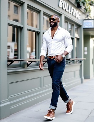 White Long Sleeve Shirt · Navy Jeans · Tobacco Leather Low Top Sneakers · Brown Leather Belt · Dark Brown Sunglasses · Silver Watch