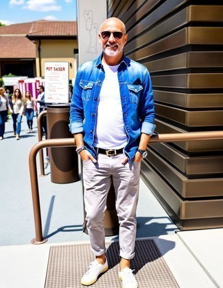 Blue Denim Jacket · White Crew-neck T-shirt · Grey Chinos · White Leather Low Top Sneakers · Black Leather Belt · Dark Purple Sunglasses
