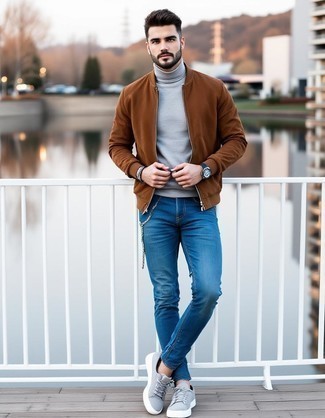 Tobacco Suede Bomber Jacket · Grey Turtleneck · Blue Skinny Jeans · Grey Suede Low Top Sneakers · Black Leather Watch · Dark Brown Bracelet