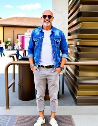 Blue Denim Jacket · White Crew-neck T-shirt · Grey Chinos · White Leather Low Top Sneakers · Black Leather Belt · Dark Purple Sunglasses