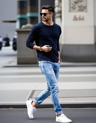 Navy Crew-neck Sweater · Blue Jeans · White Low Top Sneakers · Dark Brown Sunglasses · Silver Watch · Black Beaded Bracelet
