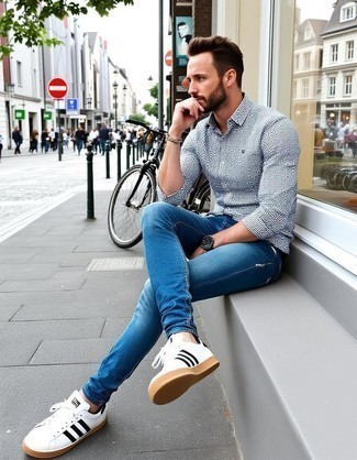 White and Navy Gingham Long Sleeve Shirt · Blue Jeans · White and Black Leather Low Top Sneakers · Black Leather Watch · Dark Brown Beaded Bracelet