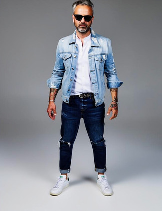 Light Blue Denim Jacket · White Long Sleeve Shirt · Navy Ripped Jeans · White and Green Leather Low Top Sneakers · Black Studded Leather Belt · Black Sunglasses