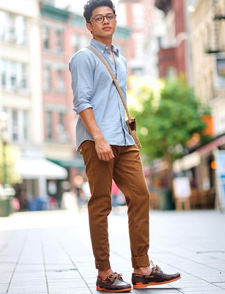 Light Blue Long Sleeve Shirt · Tobacco Jeans · Brown Leather Boat Shoes · Tan Canvas Messenger Bag · Clear Sunglasses · Black Leather Watch