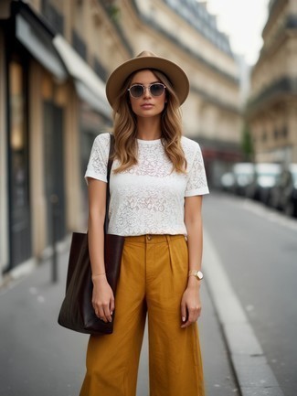 White Lace Crew-neck T-shirt · Mustard Wide Leg Pants · Dark Brown Print Leather Tote Bag · Khaki Wool Hat · Silver Sunglasses · Gold Watch