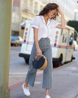 White Short Sleeve Button Down Shirt · Navy and White Vertical Striped Wide Leg Pants · White Canvas Low Top Sneakers · Navy Straw Tote Bag · Tan Sunglasses