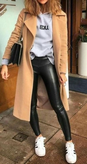 Camel Coat · Grey Print Hoodie · Black Leather Leggings · White and Black Leather Low Top Sneakers · Beige Print Canvas Satchel Bag