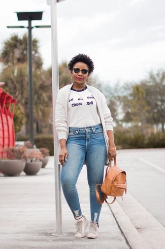 White Fleece Bomber Jacket · White and Blue Print Crew-neck T-shirt · Light Blue Skinny Jeans · White Leather Low Top Sneakers · Tan Leather Backpack · White Socks